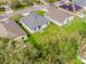 Aerial view showcases this home, its roof, and yard with surrounding houses in the neighborhood at 14410 Lake Underhill Rd, Orlando, FL 32828