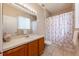 Bathroom with a vanity, mirror and a shower with curtain at 14410 Lake Underhill Rd, Orlando, FL 32828