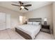 Cozy bedroom with a ceiling fan, neutral tones and two side tables at 14410 Lake Underhill Rd, Orlando, FL 32828