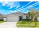 Charming single-story home with a well-maintained lawn and a two-car garage at 14410 Lake Underhill Rd, Orlando, FL 32828