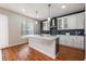 Bright kitchen with a center island, pendant lights, and wooden floors at 14410 Lake Underhill Rd, Orlando, FL 32828