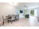 Open living space with dining area and access to the backyard through sliding doors at 14410 Lake Underhill Rd, Orlando, FL 32828