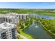 Stunning aerial view of resort buildings, a lake, and lush green landscape showcasing the community's beauty at 14501 Grove Resort Ave # 3601, Winter Garden, FL 34787