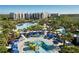 Stunning aerial view of a resort featuring pools, waterslides, and lush landscaping against a beautiful blue sky at 14501 Grove Resort Ave # 3601, Winter Garden, FL 34787