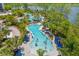 Lush aerial view of a resort pool complex nestled amongst trees, offering a serene and inviting atmosphere at 14501 Grove Resort Ave # 3601, Winter Garden, FL 34787