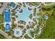 Lush aerial view of a resort pool complex, complete with waterslides, a lazy river, and plenty of lounge seating at 14501 Grove Resort Ave # 3601, Winter Garden, FL 34787