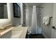 Bathroom with a well-lit mirror and a shower featuring sleek fixtures and white tile surround at 14501 Grove Resort Ave # 3601, Winter Garden, FL 34787