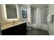 Bathroom featuring a modern vanity, toilet, and a shower with a glass door and white tile surround at 14501 Grove Resort Ave # 3601, Winter Garden, FL 34787