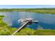 Picturesque dock featuring a gazebo and boat slips on a tranquil lake, surrounded by natural beauty at 14501 Grove Resort Ave # 3601, Winter Garden, FL 34787