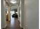 Hallway with an arched opening into the living area and wood flooring at 14501 Grove Resort Ave # 3601, Winter Garden, FL 34787