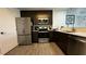 Modern kitchen features stainless steel appliances, dark cabinets, and light countertops at 14501 Grove Resort Ave # 3601, Winter Garden, FL 34787