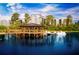 Stunning lake view with swan paddle boats docked by a gazebo in front of the condos at 14501 Grove Resort Ave # 3601, Winter Garden, FL 34787