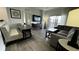 Bright living room with hardwood floors and sliding doors to a balcony at 14501 Grove Resort Ave # 3601, Winter Garden, FL 34787