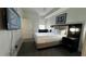Modern bedroom featuring a bed, mounted TV, nightstands and ample natural light at 14501 Grove Resort Ave # 3601, Winter Garden, FL 34787