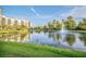 Scenic pond with a fountain feature, surrounded by lush greenery and a reflection of the nearby buildings at 14501 Grove Resort Ave # 3601, Winter Garden, FL 34787