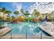 Gathering-friendly pool area with a lifeguard tower, vibrant waterslides, and lush tropical foliage at 14501 Grove Resort Ave # 3601, Winter Garden, FL 34787