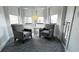Cozy sitting area with two armchairs, side table, and bright natural light from large windows at 14501 Grove Resort Ave # 3601, Winter Garden, FL 34787