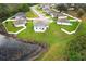 Aerial view of the property showcasing the pond, and the spacious backyard at 15216 Langsdale Ct, Mascotte, FL 34753