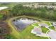 Aerial view of the property featuring a pond and backyard at 15216 Langsdale Ct, Mascotte, FL 34753