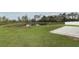 Well-manicured lawn, a serene pond, and a paver patio at 15216 Langsdale Ct, Mascotte, FL 34753