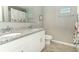 Bathroom featuring a double vanity with granite countertops and wood-look tile flooring at 15216 Langsdale Ct, Mascotte, FL 34753