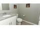 Clean bathroom featuring granite countertop and white cabinets at 15216 Langsdale Ct, Mascotte, FL 34753