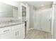 Bathroom showcasing the vanity with granite countertops, walk-in shower and neutral tones at 15216 Langsdale Ct, Mascotte, FL 34753