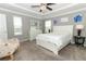 Bright bedroom offers a ceiling fan, dresser and chair for relaxing in the natural sunlight at 15216 Langsdale Ct, Mascotte, FL 34753