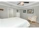 Bright bedroom features natural sunlight, comfortable chair and ceiling fan for warm days at 15216 Langsdale Ct, Mascotte, FL 34753