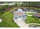 Lovely two-story home with a manicured lawn and serene pond view at 15216 Langsdale Ct, Mascotte, FL 34753