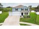 Charming two-story home with a three-car garage and a well-manicured front yard with pond view at 15216 Langsdale Ct, Mascotte, FL 34753