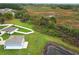 Beautiful exterior view of the home with lush green yard, pond, and conservation area at 15216 Langsdale Ct, Mascotte, FL 34753