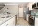 Stylish kitchen with stainless steel appliances, granite countertops, and a breakfast bar for seating at 15216 Langsdale Ct, Mascotte, FL 34753