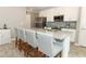 Modern kitchen with stainless appliances, white cabinetry, granite counters and seating at island at 15216 Langsdale Ct, Mascotte, FL 34753