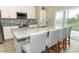 Bright kitchen with granite counters, stainless appliances, and a breakfast bar with seating at 15216 Langsdale Ct, Mascotte, FL 34753