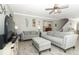 Inviting living room featuring neutral colors, comfortable seating, and modern ceiling fan at 15216 Langsdale Ct, Mascotte, FL 34753