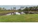 Backyard pond creating a peaceful natural environment at 15216 Langsdale Ct, Mascotte, FL 34753