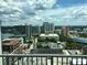 City view from balcony featuring a crane, buildings, and a partial view of a lake at 155 S Court Ave # 1613, Orlando, FL 32801