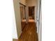 Hallway with wood floors and closet doors leading to the bathroom with tub and shower at 155 S Court Ave # 1613, Orlando, FL 32801