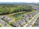Aerial view of the community homes by a pond and a forest at 17398 Saw Palmetto Ave, Clermont, FL 34714