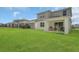 Large, well-maintained backyard with a charming two-story home and covered patio at 17398 Saw Palmetto Ave, Clermont, FL 34714