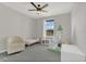 Bright bedroom featuring a teepee, cozy armchair, and a large window at 17398 Saw Palmetto Ave, Clermont, FL 34714
