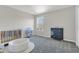 Bedroom featuring a crib, changing table, and soft carpet at 17398 Saw Palmetto Ave, Clermont, FL 34714