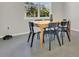 Dining area with a wooden table, overlooking a window, and features tiled floors throughout the area at 17398 Saw Palmetto Ave, Clermont, FL 34714