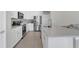 Bright kitchen featuring white cabinets, stainless steel appliances, and a tiled floor at 17398 Saw Palmetto Ave, Clermont, FL 34714