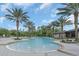 Enjoy this community pool featuring palm trees and splash fountains, with ample space for lounge chairs at 17398 Saw Palmetto Ave, Clermont, FL 34714