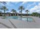 Community pool with lounge chairs, palm trees and ample deck space at 17398 Saw Palmetto Ave, Clermont, FL 34714