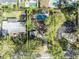 Aerial view of the home's backyard pool, lush landscaping, driveway, and surrounding neighborhood at 1821 Mohican Trl, Maitland, FL 32751