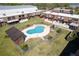 Aerial view of a townhome with a community pool, fencing and manicured lawns at 1836 N Crystal Lake Dr # 104, Lakeland, FL 33801