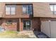 Backyard brick townhome featuring a slider, small back yard, and privacy fence at 1836 N Crystal Lake Dr # 104, Lakeland, FL 33801